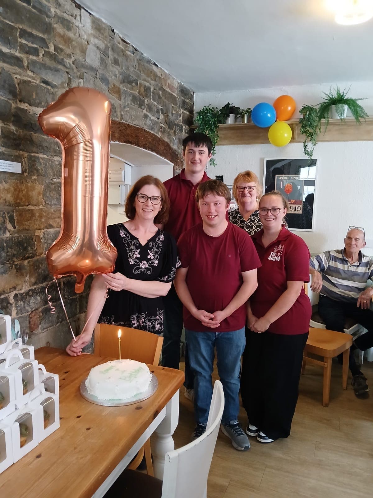 Team with balloon at The Angel Café