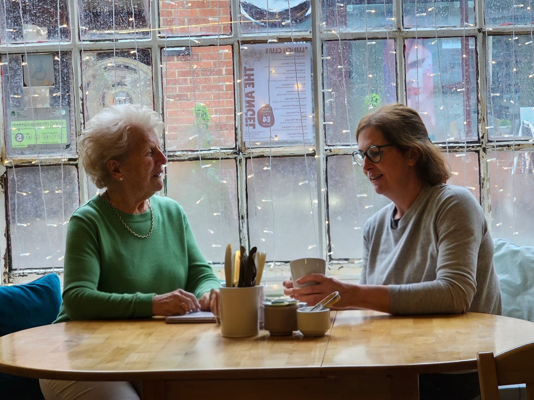 Two people enjoying coffee together in the café