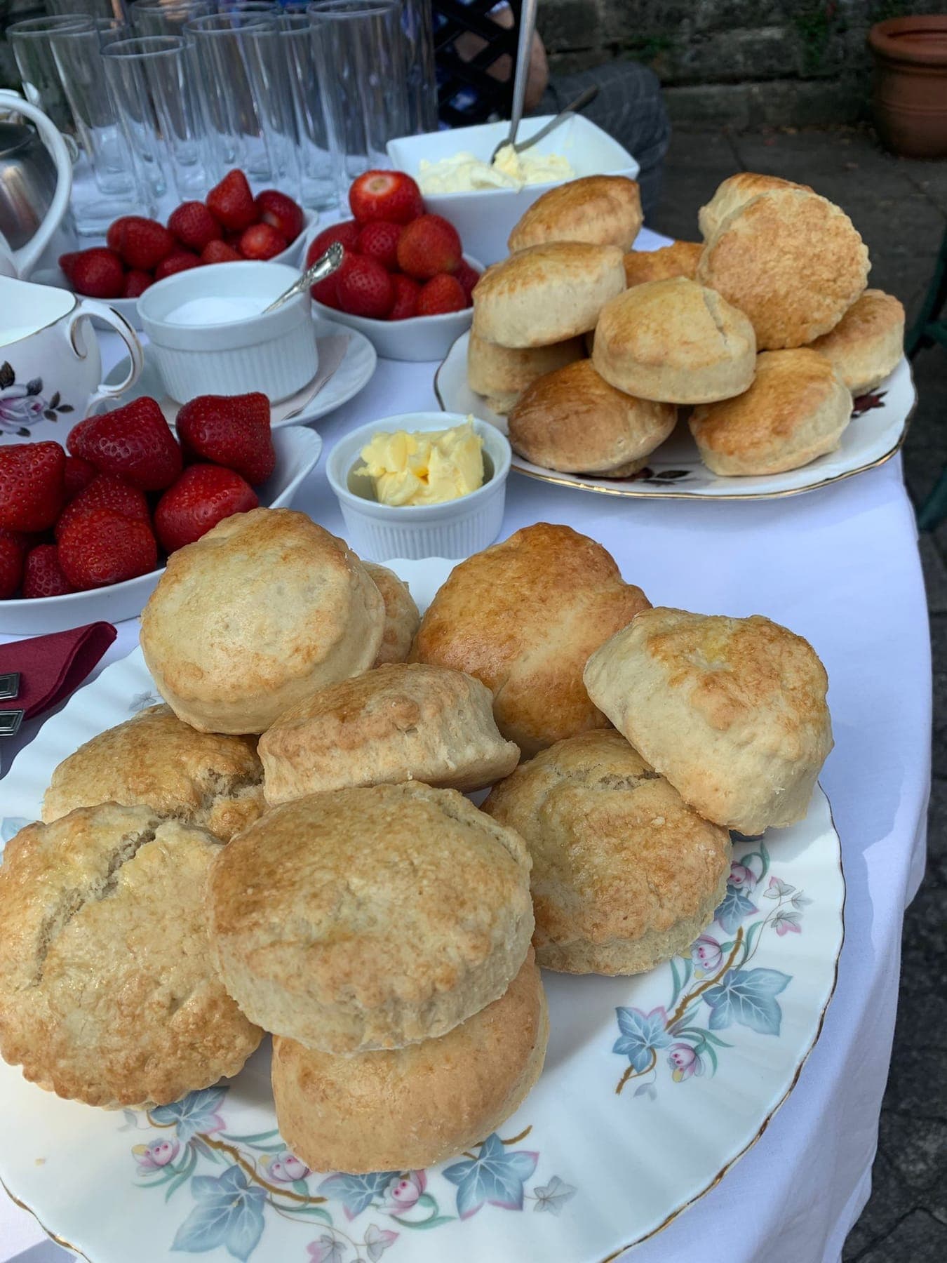 Scones with clotted cream and strawberries set out for a cream tea