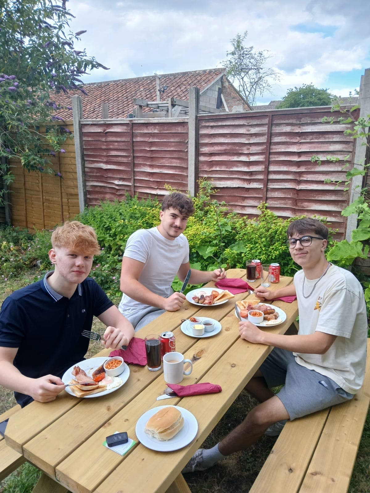 Cooked breakfasts on a picnic table in the garden