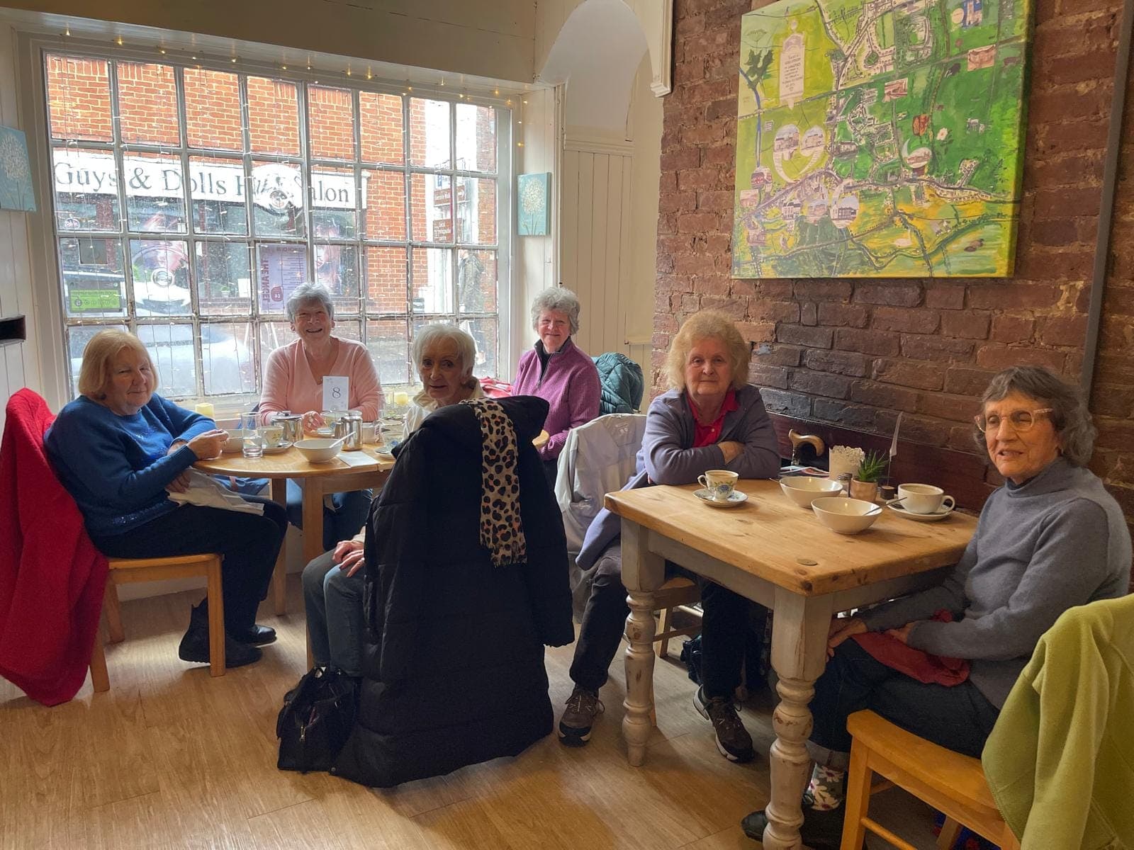 A busy morning in the café, with customers at several tables being served